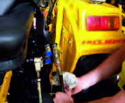 Figure cleaning the hose head and around the hydraulic outlet of the tractor